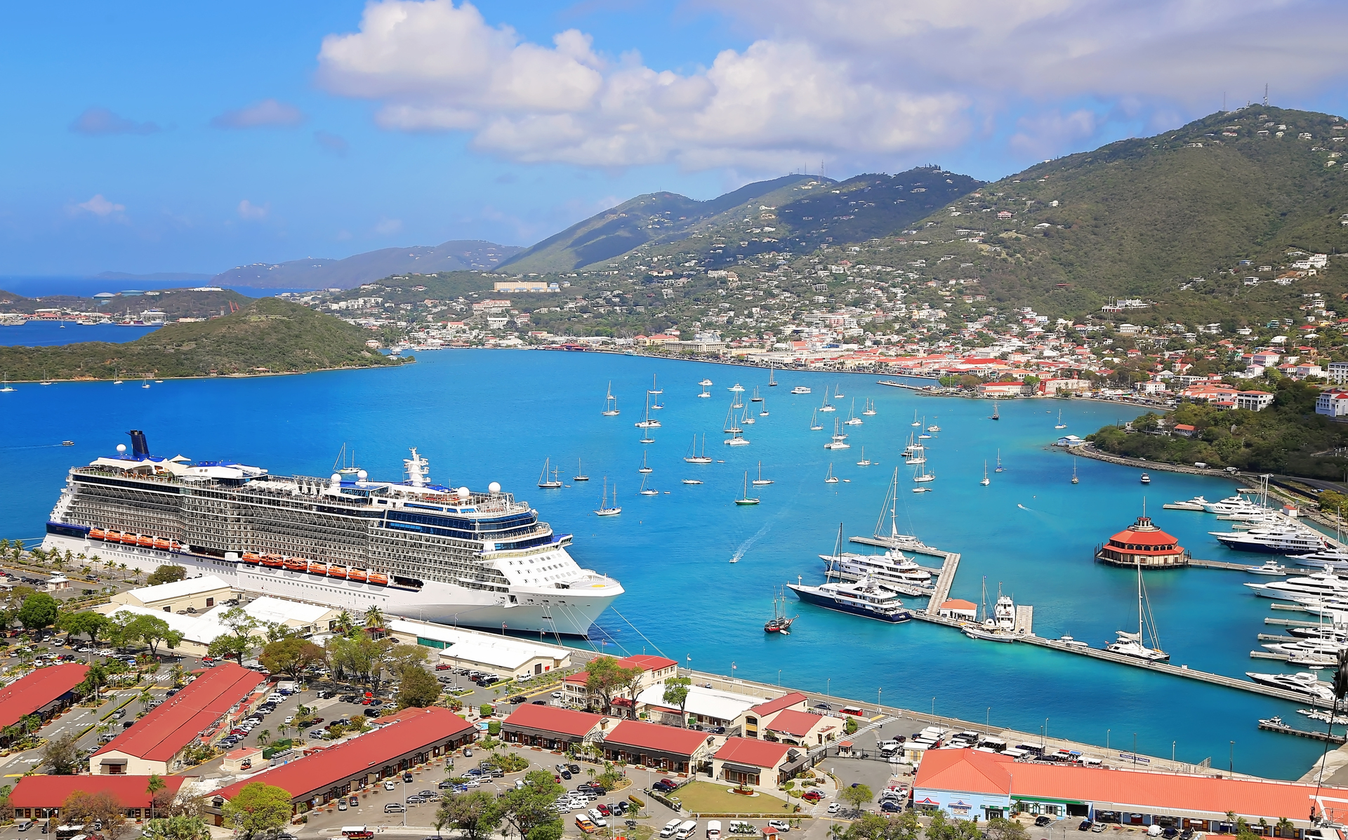 A cruise ship docked beside a Caribbean island